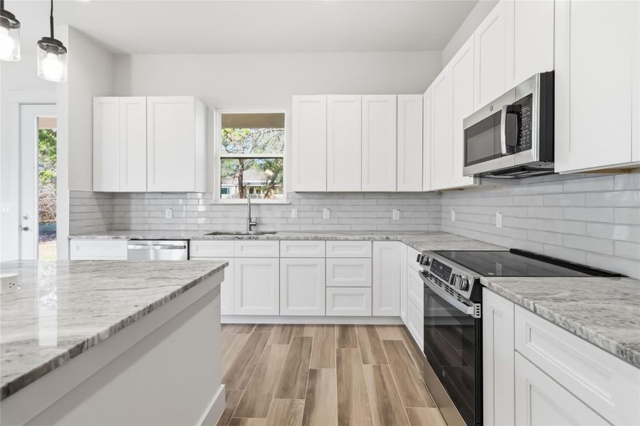 Soft close cabinets and backsplash with subway tile