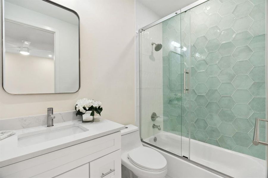Full bathroom featuring shower / bath combination with glass door and vanity