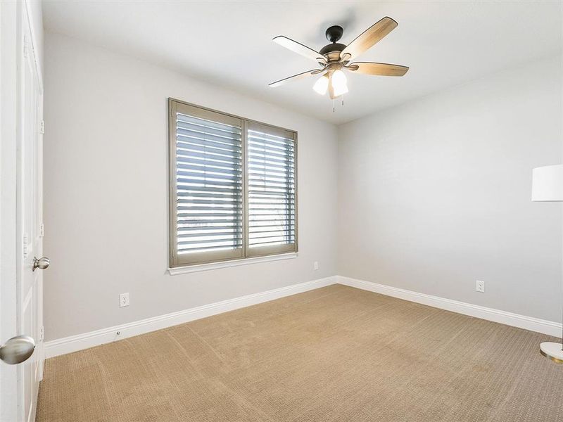 Carpeted spare room with ceiling fan