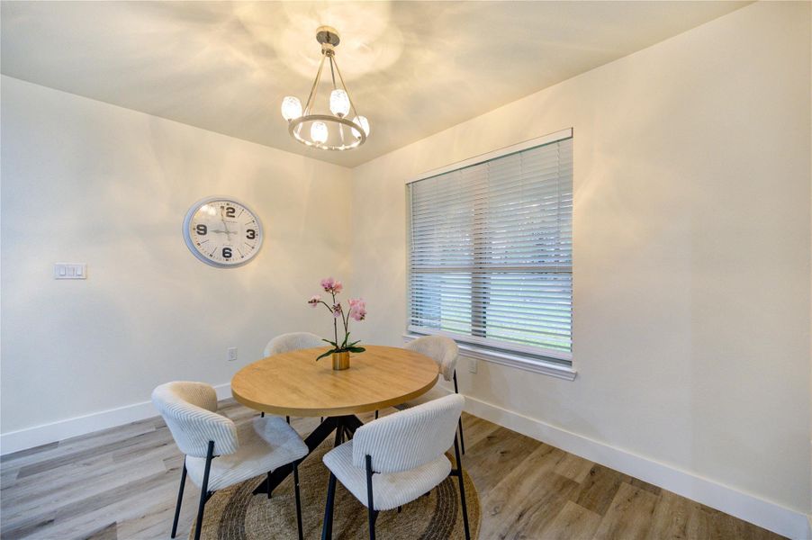Bright and inviting dining area with elegant lighting and a charming window view.