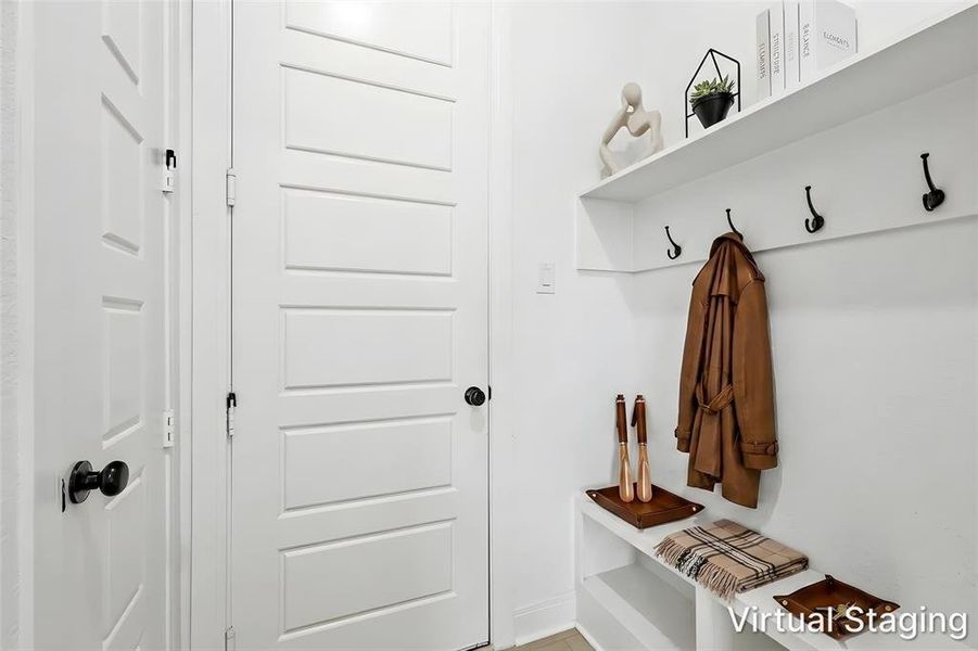 In this hall, you will find access to the mudroom, spacious laundry, another closet, and a powder room. In this hall, you will find access to the mudroom, spacious laundry, another closet, and a powder room.