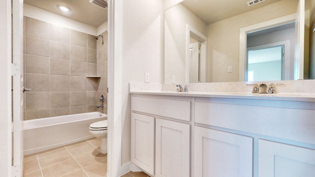 A bathroom with a tub toilet and sink.