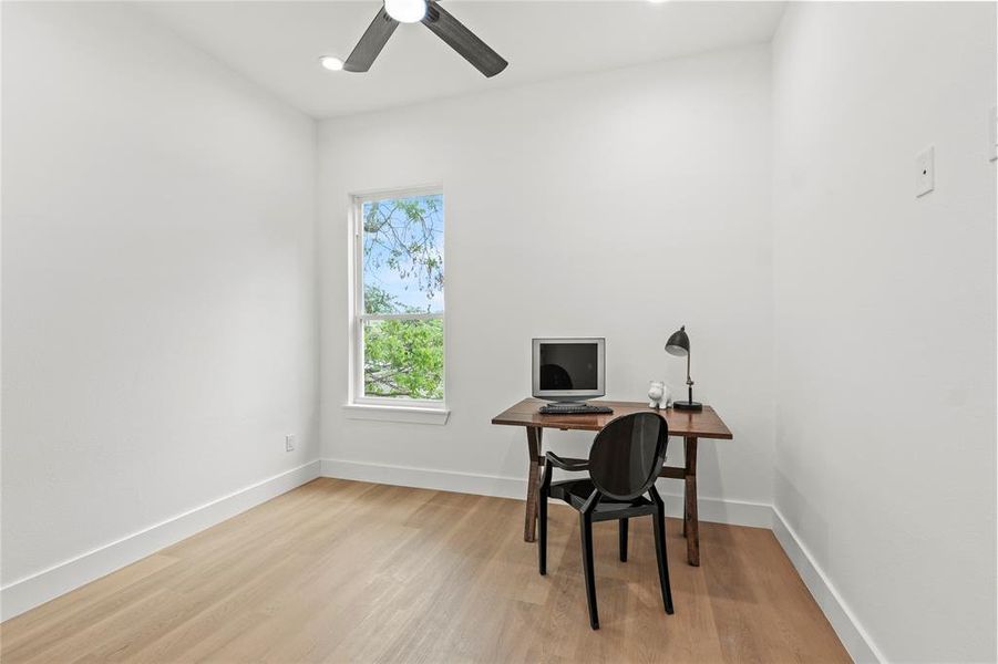 Office area with recessed lighting, light wood-style floors, a ceiling fan, and baseboards