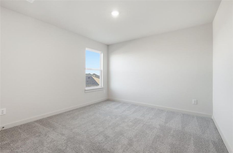Neutral-toned room featuring a single window, recessed lighting, light gray carpeting, and white baseboards Neutral-toned room featuring a single window, recessed lighting, light gray carpeting, and white baseboards