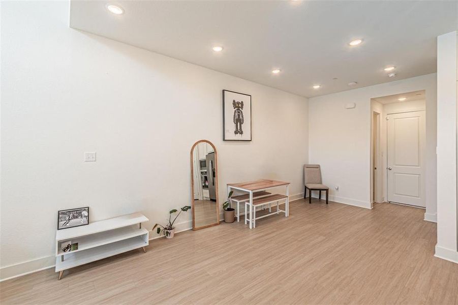 Living area with recessed lighting and light wood-type flooring