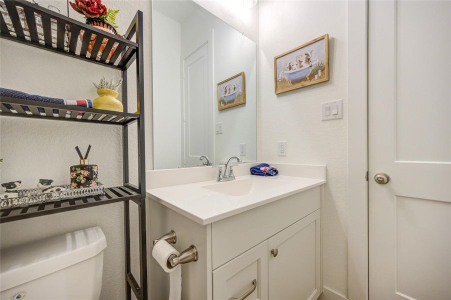 Convenient half bath with a bright vanity and clean, modern finishes. Convenient half bath with a bright vanity and clean, modern finishes.