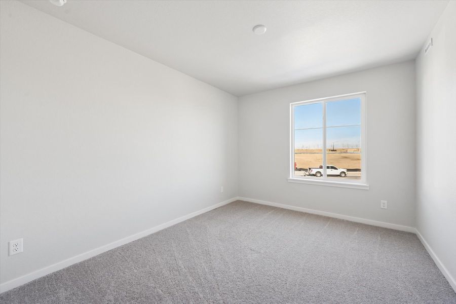 A room with a window and a car outside.