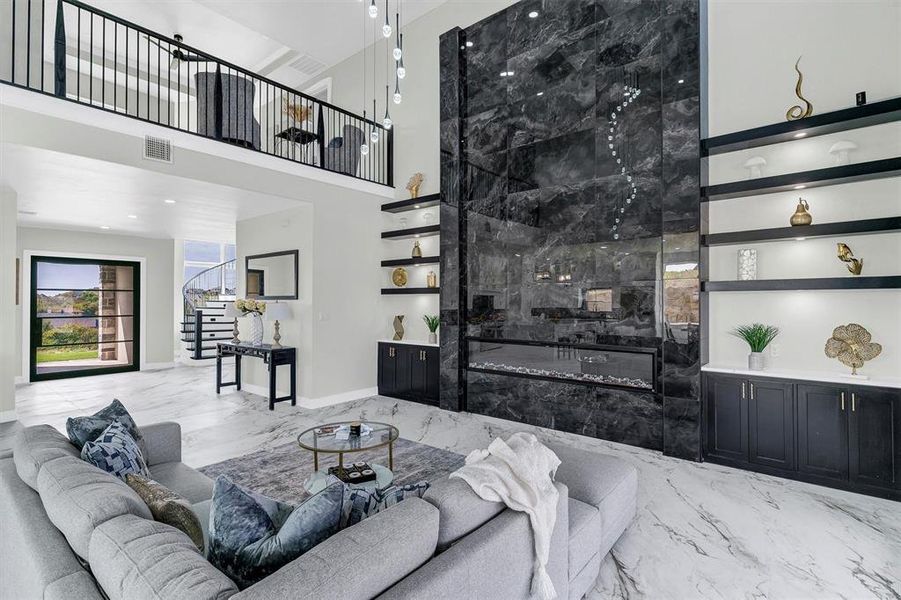 Living room with a towering ceiling and a large fireplace