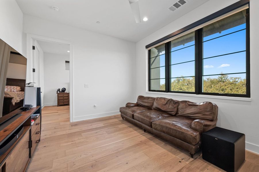 Living room featuring baseboards, visible vents, recessed lighting, and light wood-type flooring Living room featuring baseboards, visible vents, recessed lighting, and light wood-type flooring