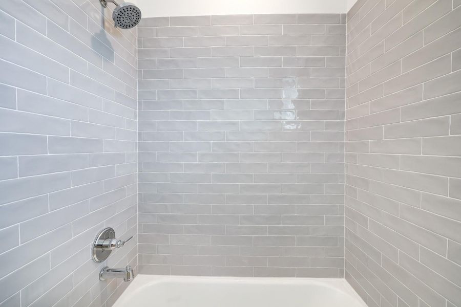 Modern bathroom with sleek subway tiles and a luxurious rainfall showerhead, creating a serene spa-like experience. Modern bathroom with sleek subway tiles and a luxurious rainfall showerhead, creating a serene spa-like experience.