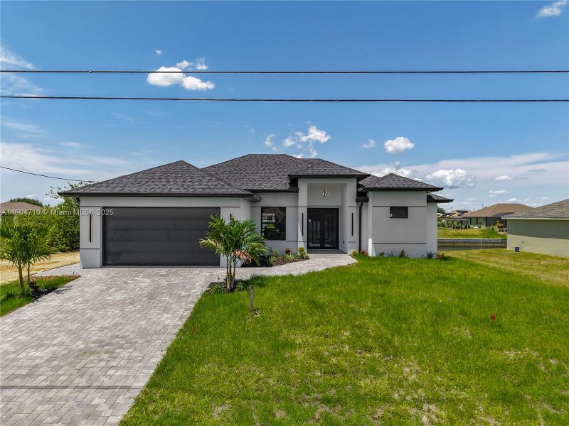 Front exterior of a new home in , Cape Coral, FL, highlighting curb appeal (Image 1). Front exterior of a new home in , Cape Coral, FL, highlighting curb appeal (Image 1).
