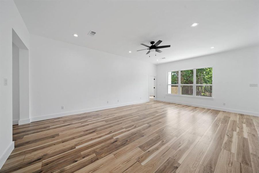 Unfurnished room with light hardwood / wood-style flooring and ceiling fan