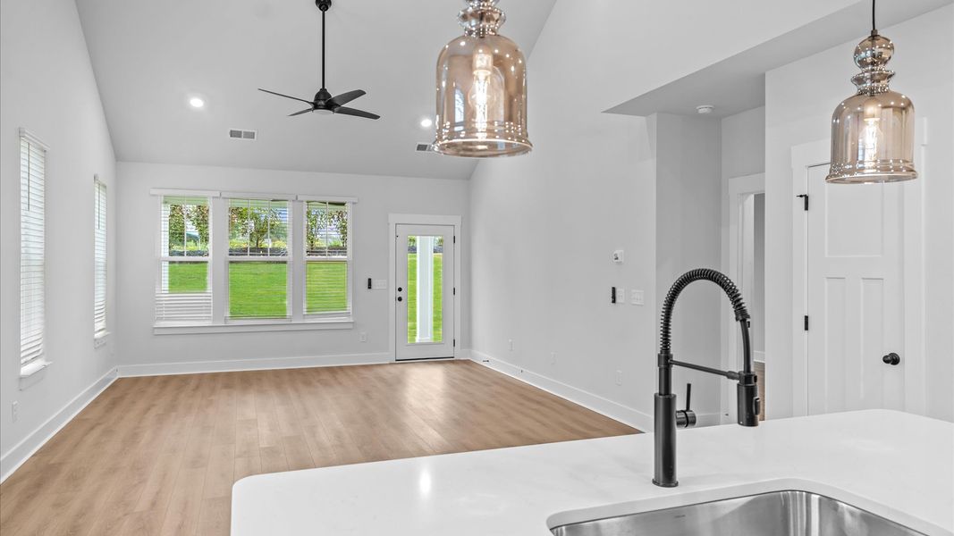 Accomplished design in this vibrant family room with two-story ceilings and open-concept flow at Silo Ridge by DRB Homes