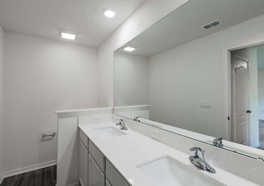 The master bathroom has a spacious double sink vanity