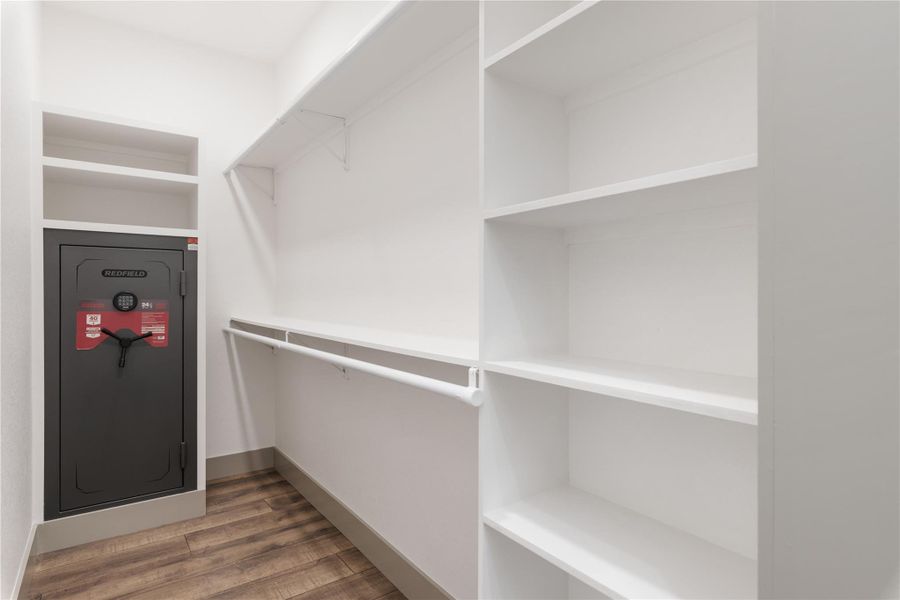Walk in closet with wood finished floors