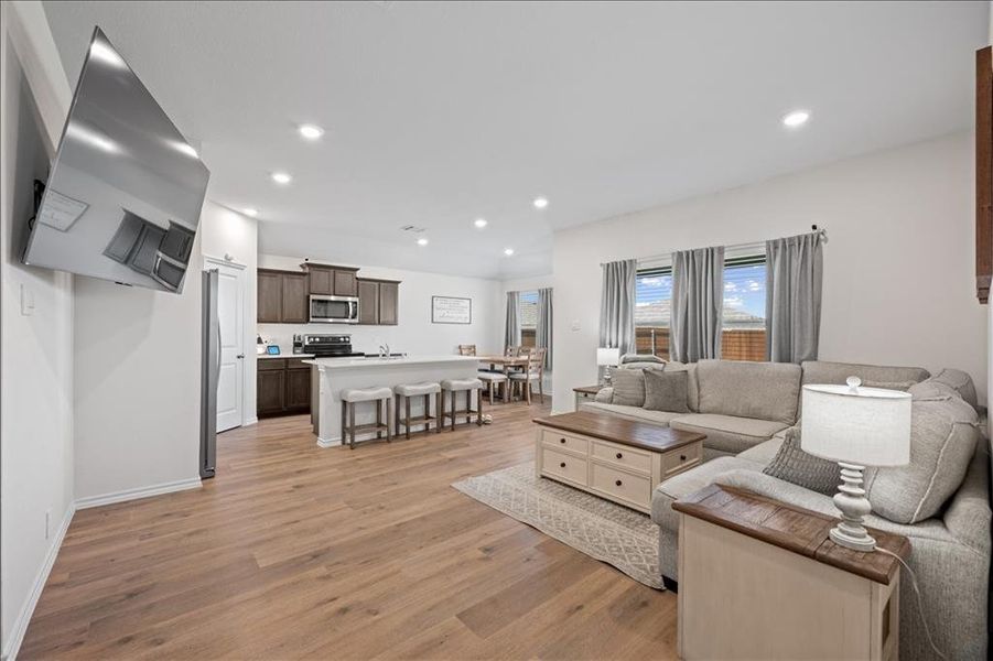 Living room featuring light wood-type flooring and recessed lighting Living room featuring light wood-type flooring and recessed lighting