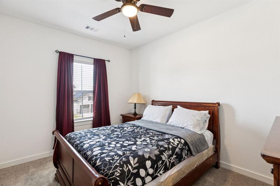 Bedroom featuring carpet flooring and ceiling fan Bedroom featuring carpet flooring and ceiling fan