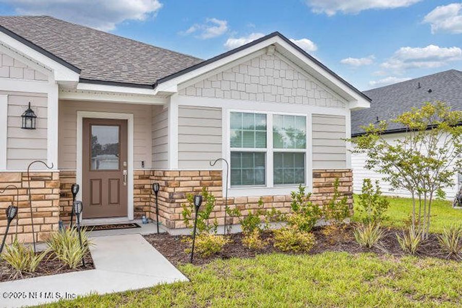 Front exterior of a new home in Edinburgh Village, Jacksonville, FL, highlighting curb appeal (Image 24). Front exterior of a new home in Edinburgh Village, Jacksonville, FL, highlighting curb appeal (Image 24).