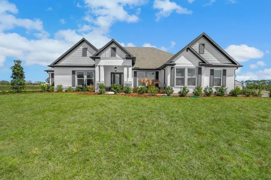 Front exterior of a new home in , Fruitland Park, FL, highlighting curb appeal (Image 1). Front exterior of a new home in , Fruitland Park, FL, highlighting curb appeal (Image 1).