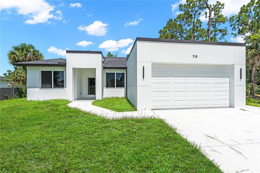Front exterior of a new home in , Lehigh Acres, FL, highlighting curb appeal (Image 2). Front exterior of a new home in , Lehigh Acres, FL, highlighting curb appeal (Image 2).