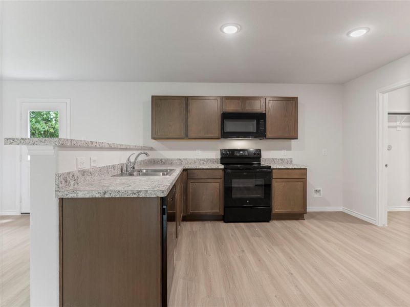 Sleek kitchen featuring modern black appliances for a stylish, cohesive look.