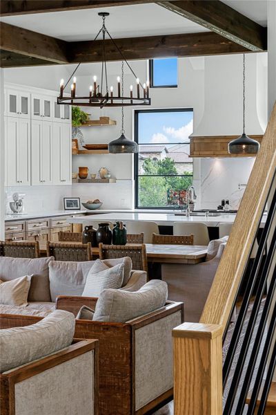 Living room featuring sink and beam ceiling