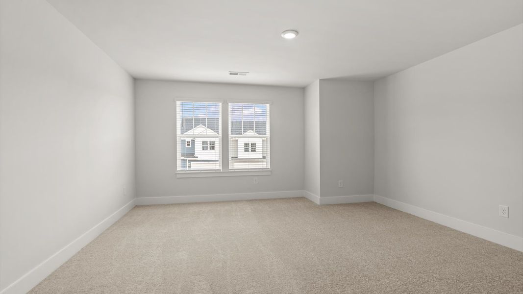 Memorable space with walk-in closet, soft carpeting, and striking natural light from large windows