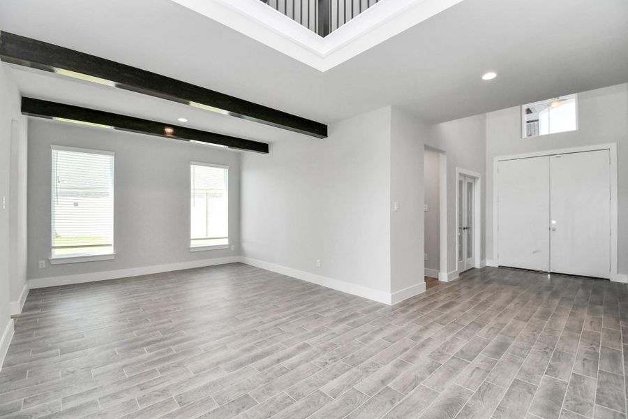Craft enduring memories with loved ones around the table! This roomy dining area boasts stylish flooring, personalized paint, and is conveniently situated next to the family room and kitchen, fostering an open and inclusive ambiance. Sample photo of completed home with similar floor plan. Actual colors and selections may vary.