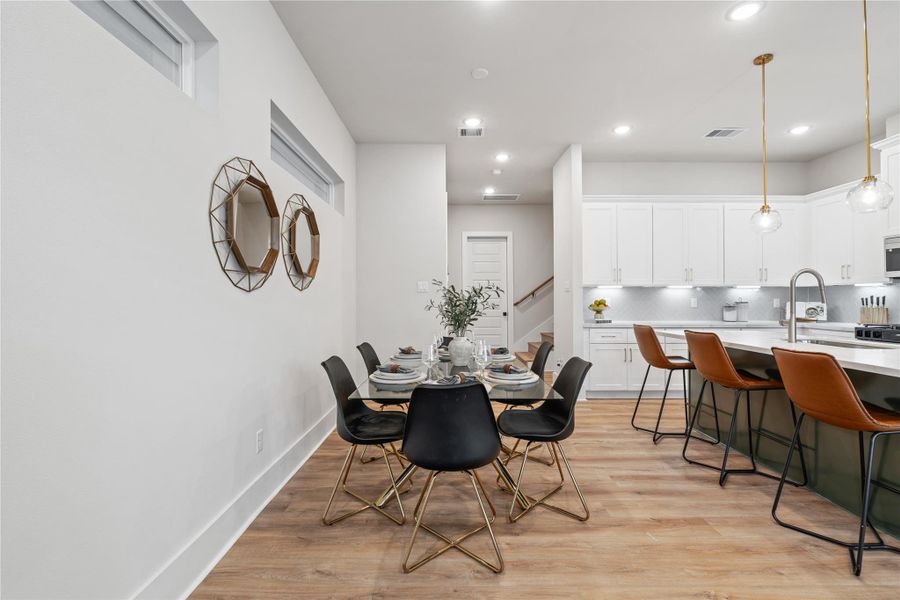 A defined dining space that integrates effortlessly with the kitchen, positioned directly off the island to enhance flow. Generous proportions allow for seating up to six, ideal for both intimate meals and larger gatherings.