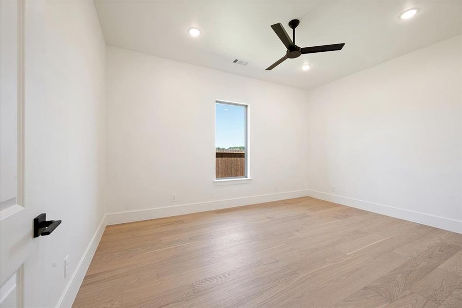 Unfurnished room featuring light hardwood / wood-style flooring and ceiling fan