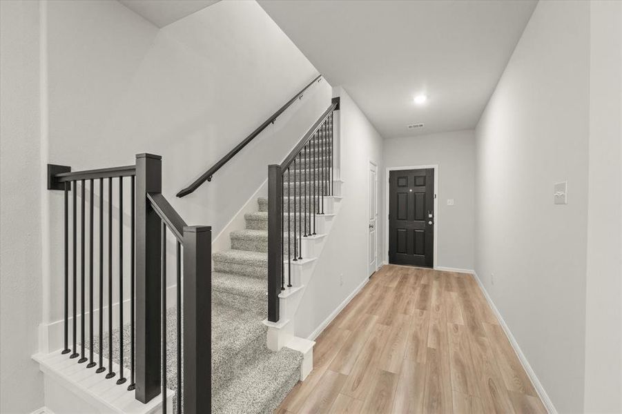 Foyer with light hardwood / wood-style flooring