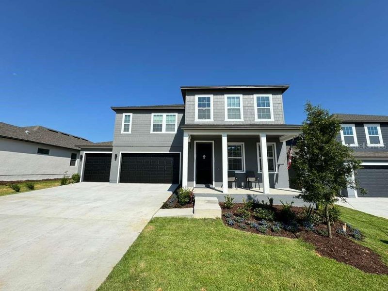 Front exterior of a new home in , Minneola, FL, highlighting curb appeal (Image 2). Front exterior of a new home in , Minneola, FL, highlighting curb appeal (Image 2).