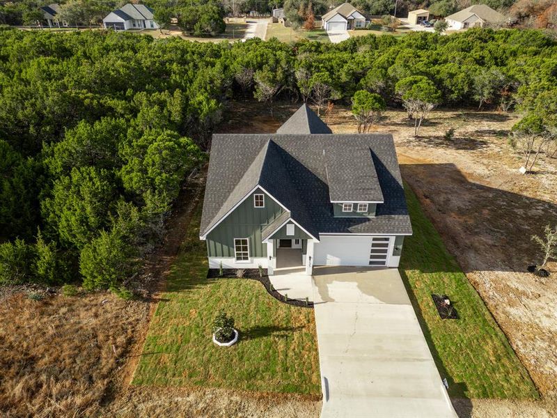 Front exterior of a new home in , Whitney, TX, highlighting curb appeal (Image 18). Front exterior of a new home in , Whitney, TX, highlighting curb appeal (Image 18).