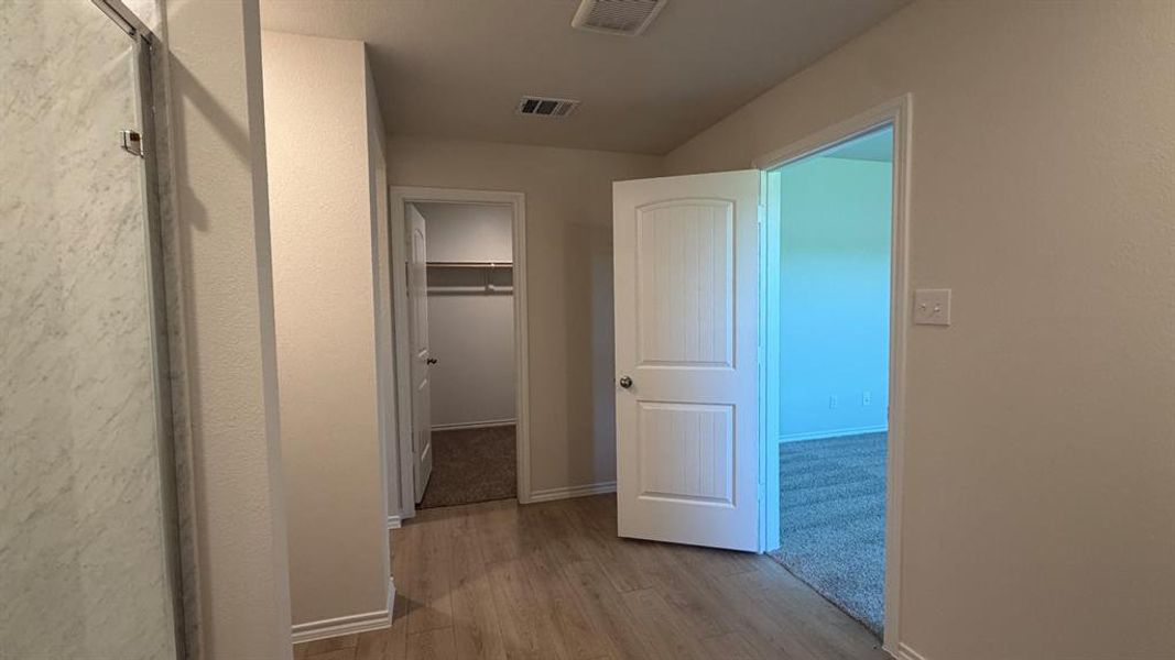Hallway featuring wood-finish flooring
