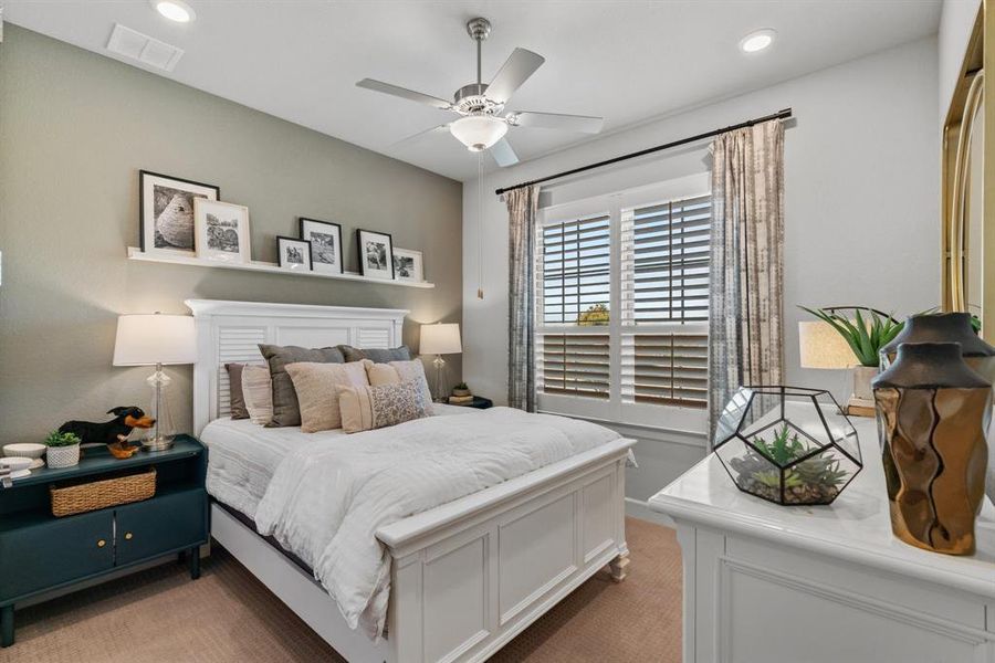 Recessed lighting and a ceiling fan in this first floor bedroom.