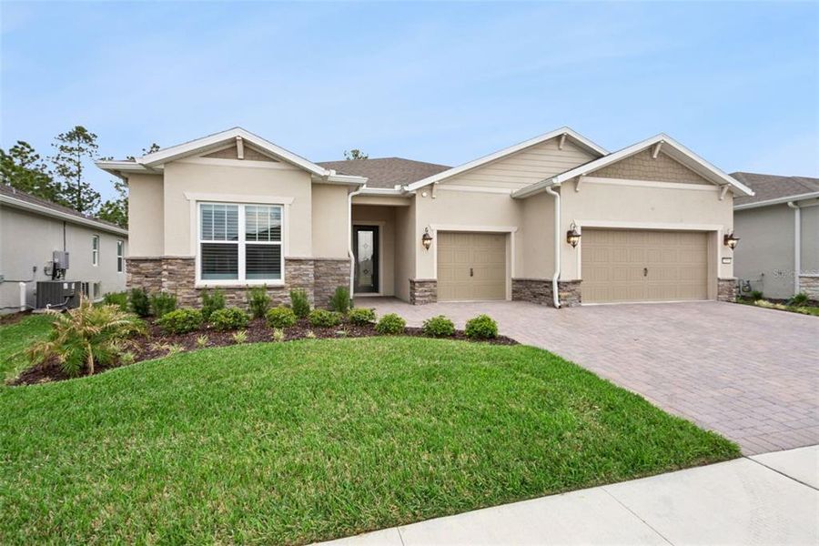 Front exterior of a new home in Del Webb Sunbridge, St. Cloud, FL, highlighting curb appeal (Image 30). Front exterior of a new home in Del Webb Sunbridge, St. Cloud, FL, highlighting curb appeal (Image 30).