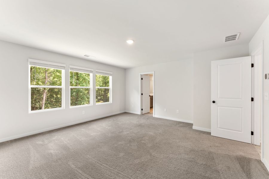 A room with white walls and a door.
