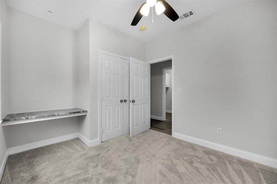 Unfurnished bedroom featuring a closet, carpet flooring, visible vents, and baseboards Unfurnished bedroom featuring a closet, carpet flooring, visible vents, and baseboards