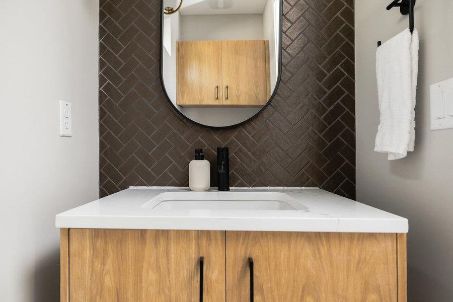 Bathroom with decorative backsplash and vanity Bathroom with decorative backsplash and vanity