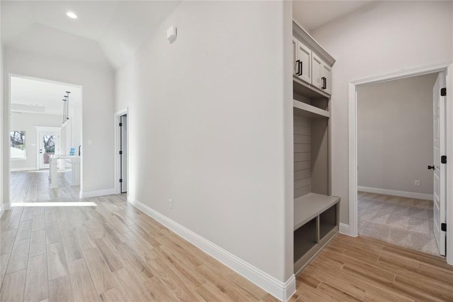 Mudroom featuring lofted ceiling