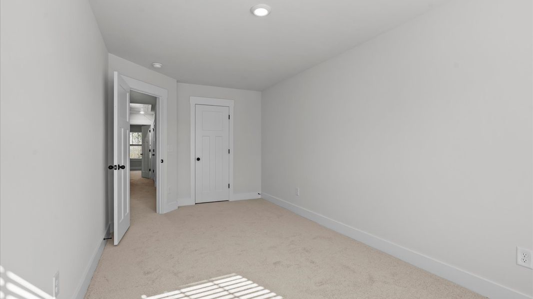 Notable bedroom offering soft carpet, a walk-in closet, and expansive windows overlooking the yard at Gresham Station