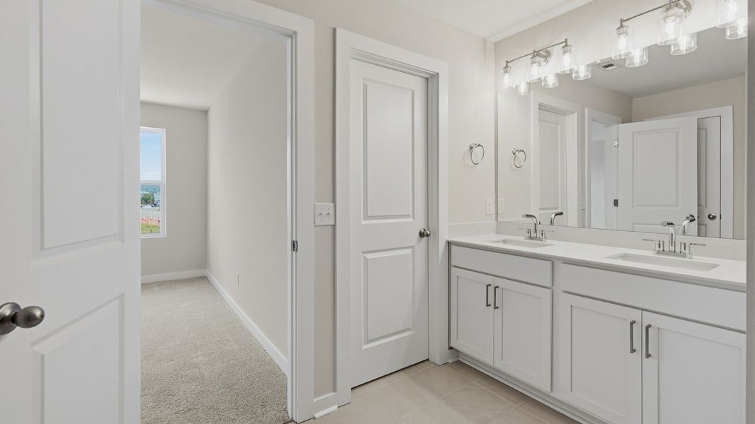 Primary bathroom with elevated features such as dual vanities