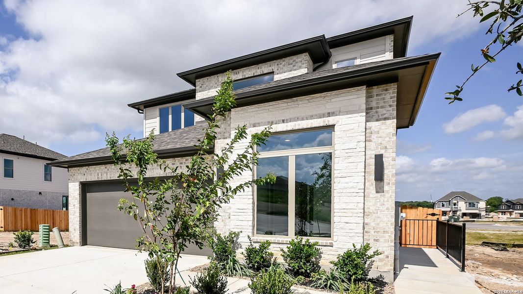 Front exterior of a new home in Legacy at Lake Dunlap, New Braunfels, TX, highlighting curb appeal (Image 21). Front exterior of a new home in Legacy at Lake Dunlap, New Braunfels, TX, highlighting curb appeal (Image 21).