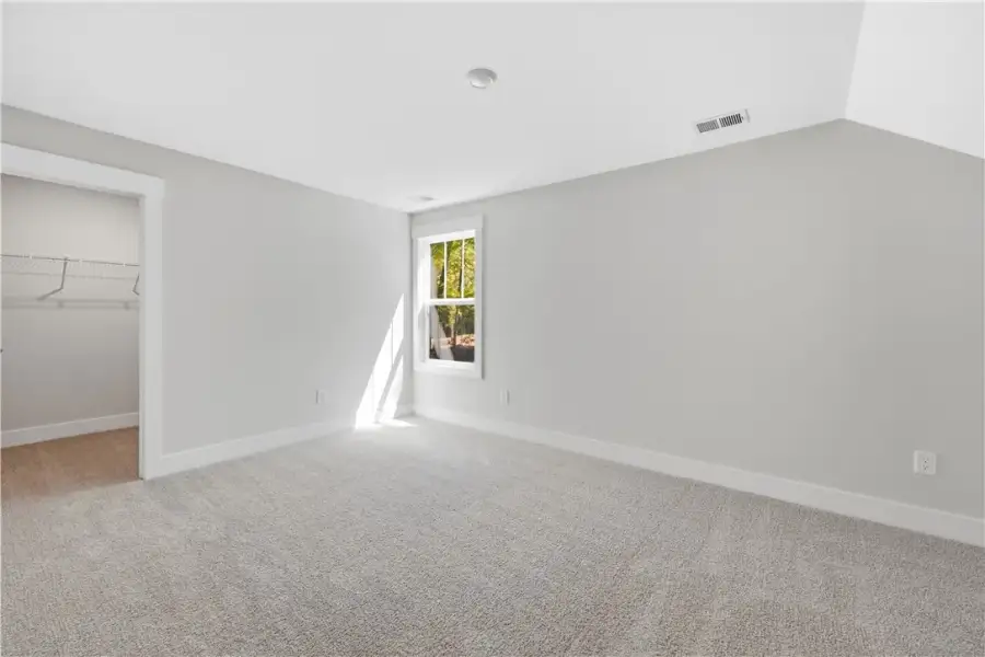 Plush carpeting and a walk-in closet highlight thi