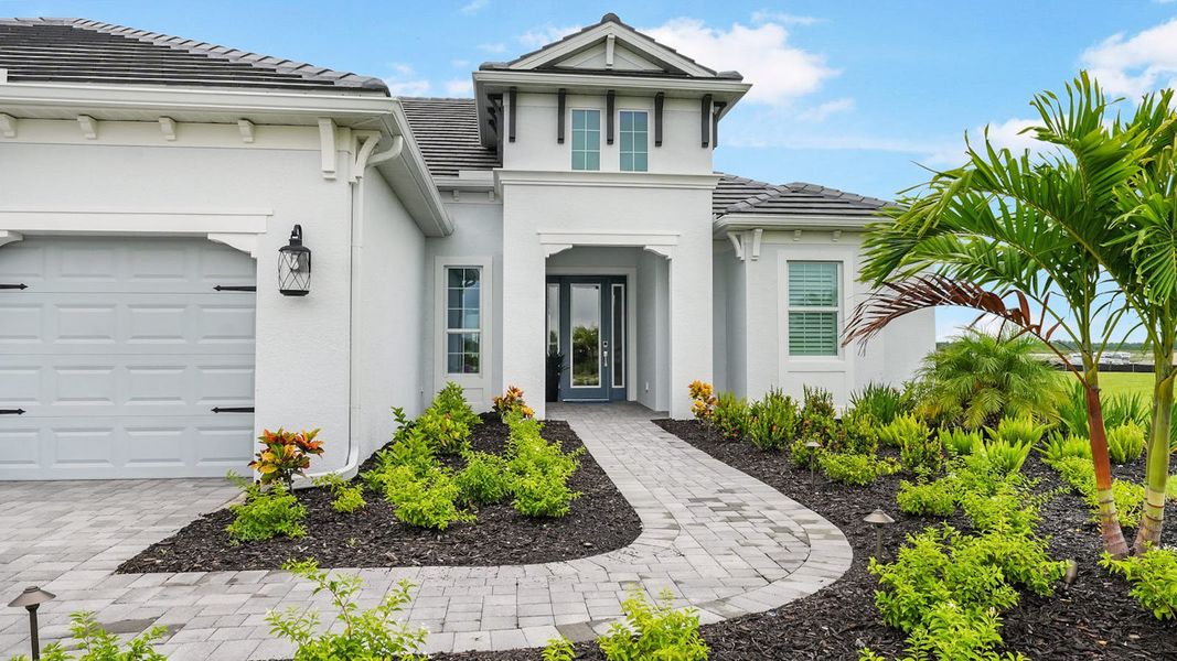 Front exterior of a new home in SkySail Real Estate and Homes for Sale in Naples, FL - Neal Communities, Naples, FL, highlighting curb appeal (Image 20). Front exterior of a new home in SkySail Real Estate and Homes for Sale in Naples, FL - Neal Communities, Naples, FL, highlighting curb appeal (Image 20).