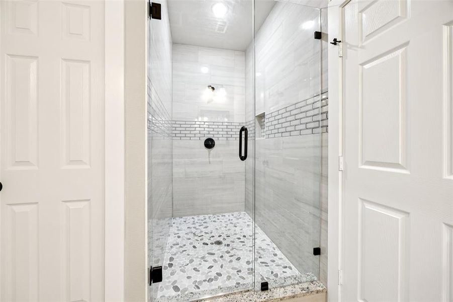 Bathroom featuring a shower stall Bathroom featuring a shower stall