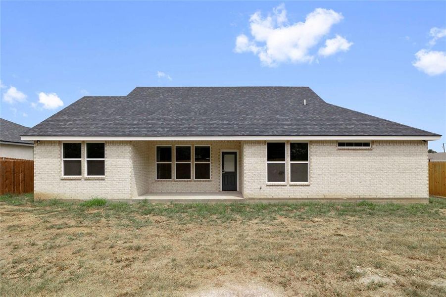 Rear view of property featuring brick siding, a patio, and roof with shingles Rear view of property featuring brick siding, a patio, and roof with shingles