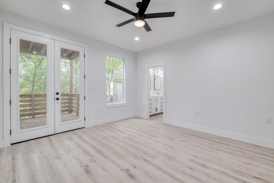A tranquil primary bedroom with a private balcony, offering serene outdoor access. A tranquil primary bedroom with a private balcony, offering serene outdoor access.