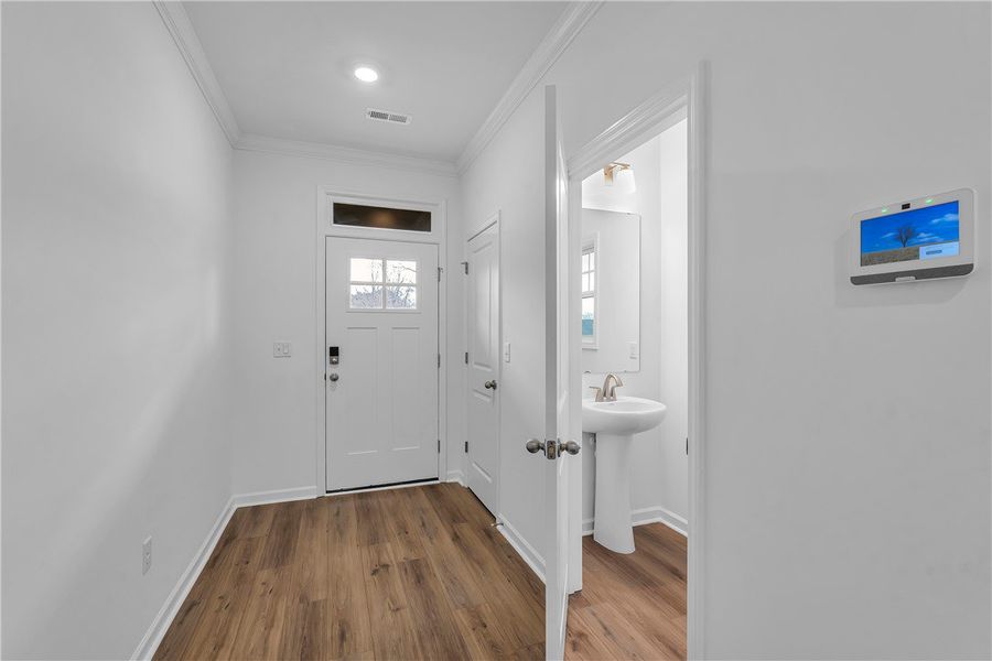 This entry welcomes with rich hardwood flooring le This entry welcomes with rich hardwood flooring le