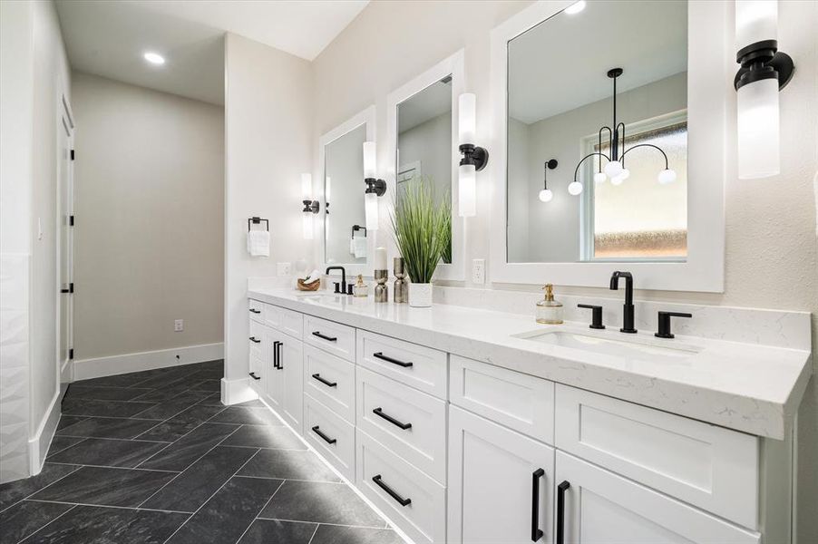 Bathroom with tile patterned flooring, vanity, and a chandelier